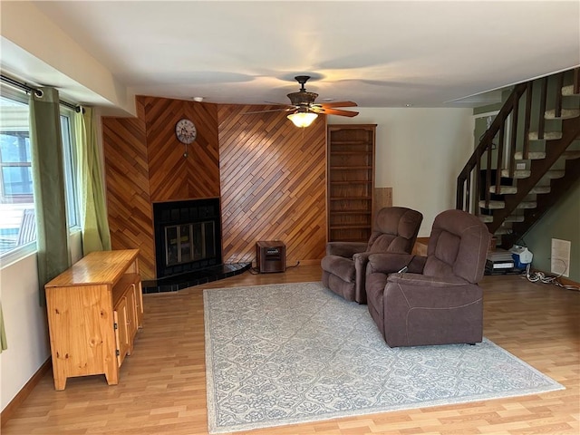 30 Regis Dr Unit 76, Staten Island, NY 10314 - living area with stairs, wooden walls, ceiling fan, light wood-type flooring, and a multi sided fireplace