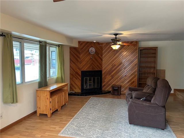 30 Regis Dr Unit 76, Staten Island, NY 10314 - living room featuring ceiling fan, light wood-type flooring, a large fireplace, and wooden walls