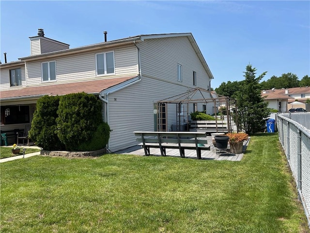 30 Regis Dr Unit 76, Staten Island, NY 10314 - back of house with a fenced backyard and a chimney