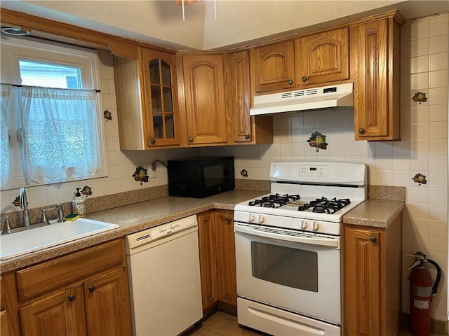 30 Regis Dr Unit 76, Staten Island, NY 10314 - kitchen with white appliances, under cabinet range hood, and brown cabinets