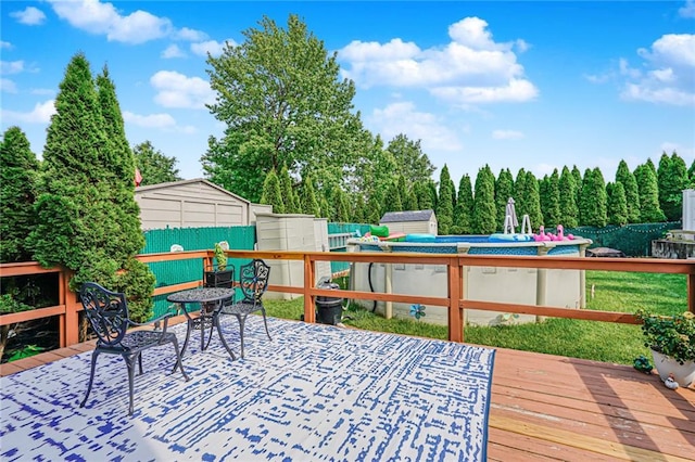 46 Mosely Ave, Staten Island, NY 10312 - wooden deck featuring a storage shed, a fenced backyard, and an outdoor pool