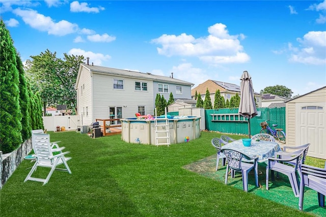 46 Mosely Ave, Staten Island, NY 10312 - back of property with a storage unit, a fenced backyard, and outdoor dining space