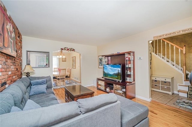 46 Mosely Ave, Staten Island, NY 10312 - living area featuring stairway, light wood finished floors, and a chandelier