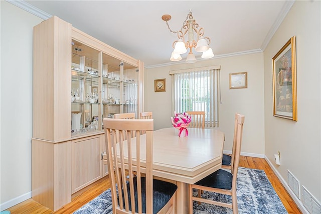 46 Mosely Ave, Staten Island, NY 10312 - dining space featuring a chandelier, light wood finished floors, and ornamental molding