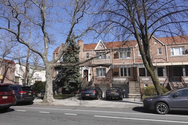 4709 Bedford Ave, Brooklyn, NY 11235 - multi unit property featuring stairway, brick siding, a chimney, an attached garage, and driveway
