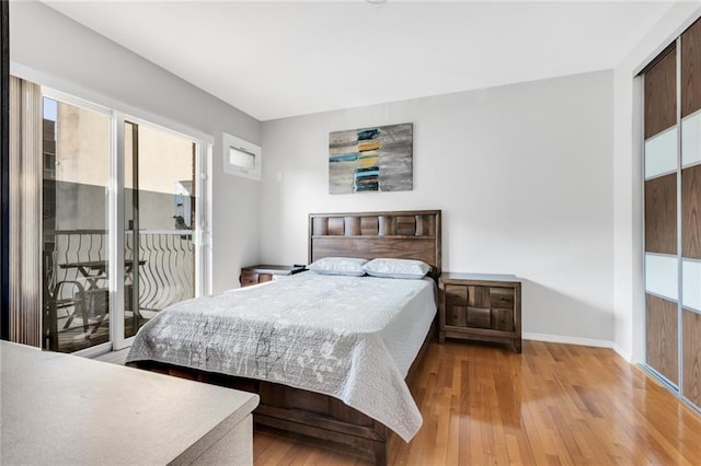 135 28th Ave Unit 2A, Brooklyn, NY 11214 - bedroom with wood-type flooring and access to exterior
