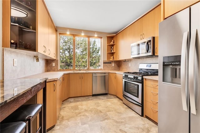 135 28th Ave Unit 2A, Brooklyn, NY 11214 - kitchen featuring stainless steel appliances, open shelves, tasteful backsplash, and light stone counters