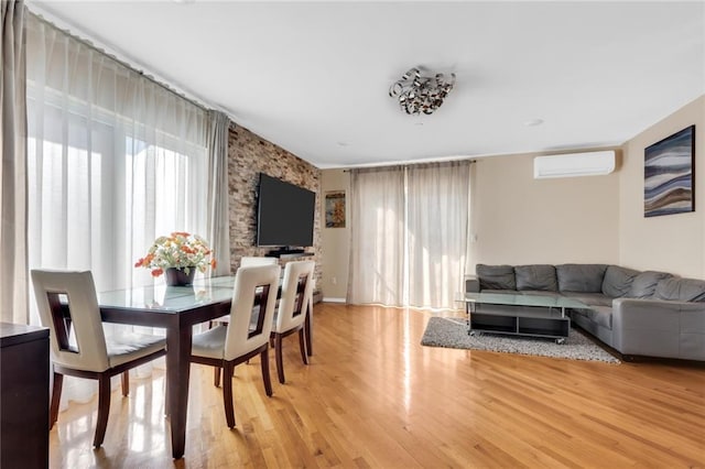 135 28th Ave Unit 2A, Brooklyn, NY 11214 - dining space with a wall unit AC, light wood-style flooring, and an accent wall