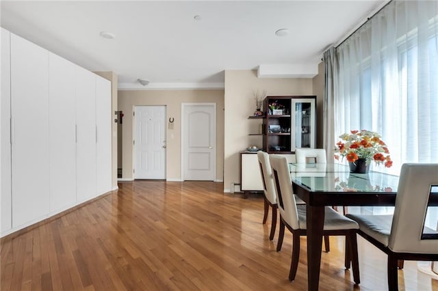 135 28th Ave Unit 2A, Brooklyn, NY 11214 - dining space featuring wood finished floors and crown molding