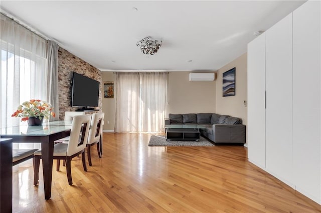 135 28th Ave Unit 2A, Brooklyn, NY 11214 - dining room with a wall unit AC and light wood-type flooring