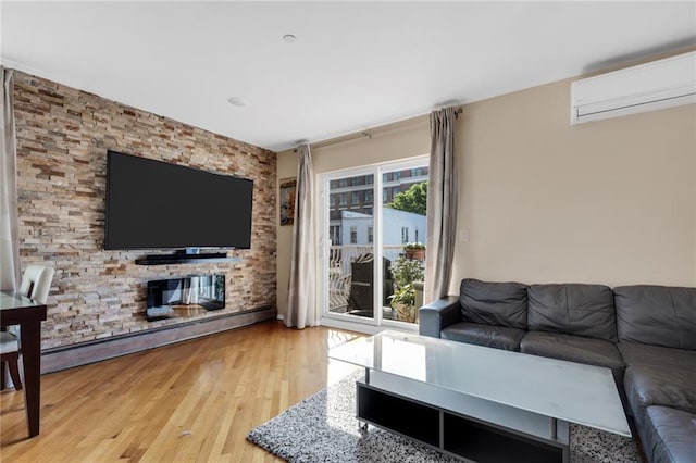 135 28th Ave Unit 2A, Brooklyn, NY 11214 - living room with a wall unit AC, wood finished floors, and a baseboard heating unit