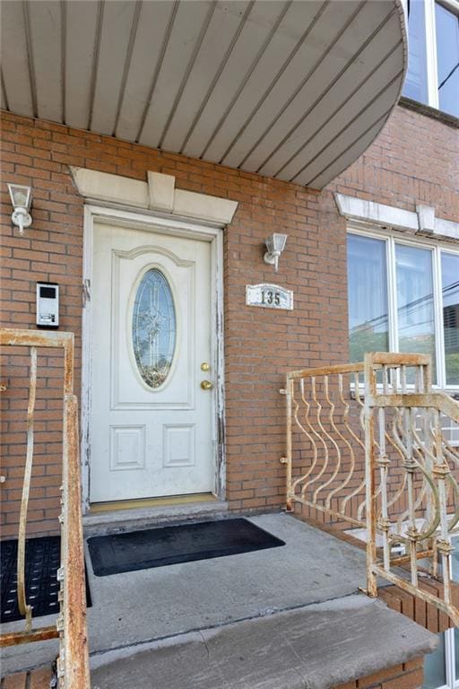 135 28th Ave Unit 2A, Brooklyn, NY 11214 - doorway to property with brick siding and a porch