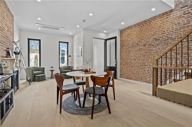 320 10th St, Brooklyn, NY 11215 - dining space featuring light wood-style flooring, brick wall, stairway, and recessed lighting