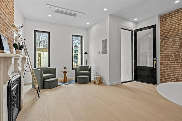 320 10th St, Brooklyn, NY 11215 - entryway with wood finished floors, electric panel, recessed lighting, and brick wall
