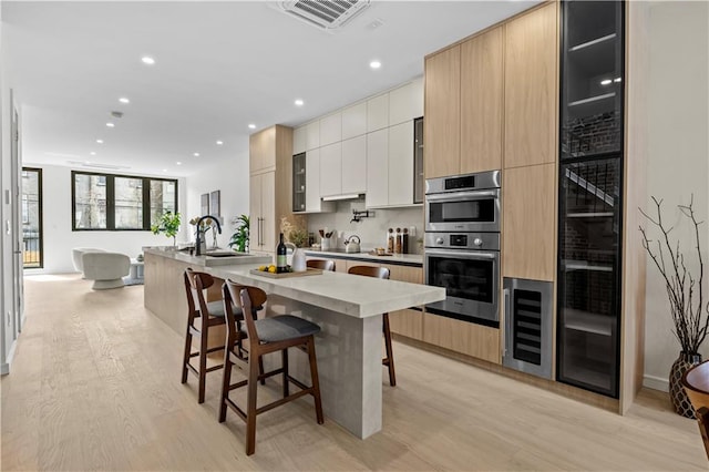 320 10th St, Brooklyn, NY 11215 - kitchen with beverage cooler, modern cabinets, light wood finished floors, and recessed lighting