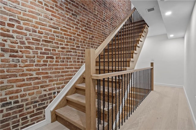 320 10th St, Brooklyn, NY 11215 - stairway featuring brick wall, wood finished floors, and recessed lighting