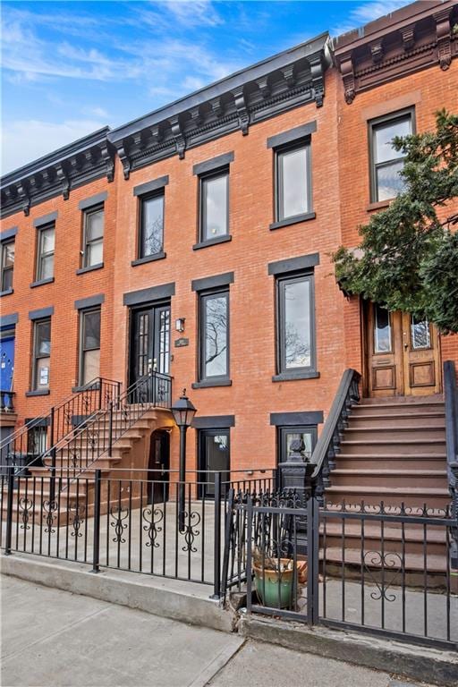 320 10th St, Brooklyn, NY 11215 - townhome / multi-family property featuring a fenced front yard and brick siding