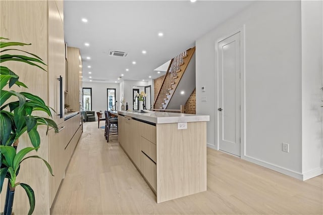 320 10th St, Brooklyn, NY 11215 - kitchen featuring modern cabinets, light brown cabinets, light wood-type flooring, a large island, and recessed lighting