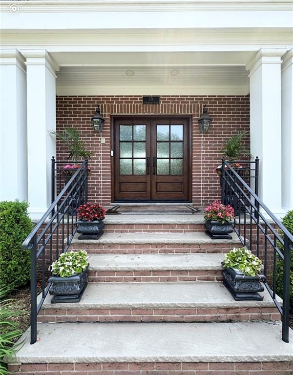 274 S Railroad St, Staten Island, NY 10312 - doorway to property featuring french doors, covered porch, and brick siding