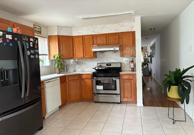30 Winegar Ln, Staten Island, NY 10310 - kitchen featuring black fridge with ice dispenser, stainless steel gas range, dishwasher, under cabinet range hood, and light countertops