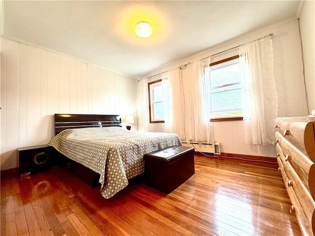 3516 Fillmore Ave, Brooklyn, NY 11234 - bedroom featuring a baseboard heating unit, wood-type flooring, and ornamental molding
