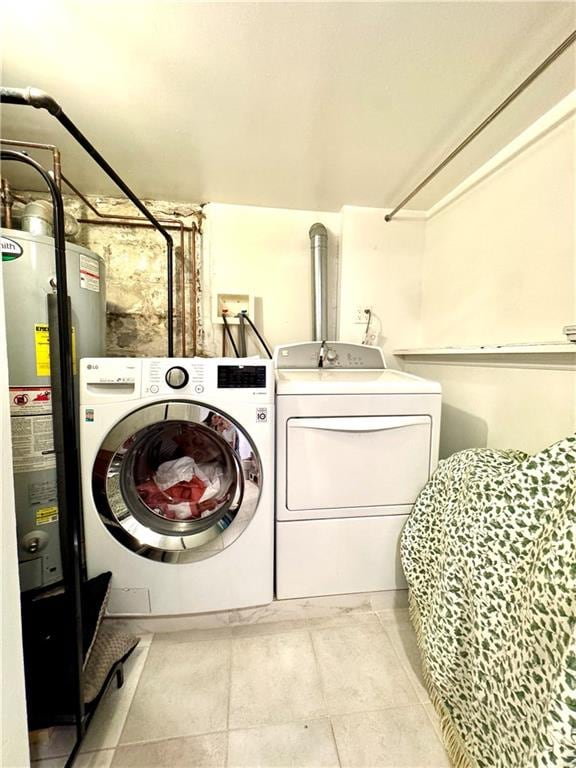 3516 Fillmore Ave, Brooklyn, NY 11234 - washroom featuring water heater, washing machine and dryer, and light tile patterned floors
