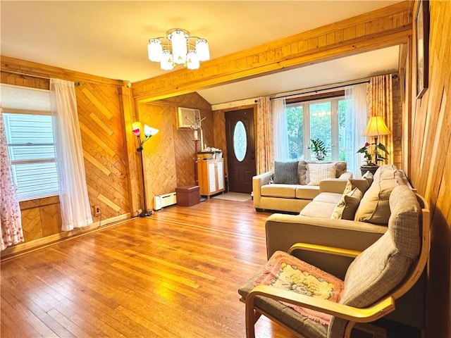 3516 Fillmore Ave, Brooklyn, NY 11234 - living room with a baseboard radiator, wood walls, hardwood / wood-style floors, and a chandelier