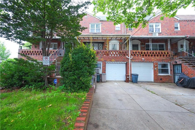 1296 E 54th St, Brooklyn, NY 11234 - view of front facade featuring driveway, an attached garage, and brick siding