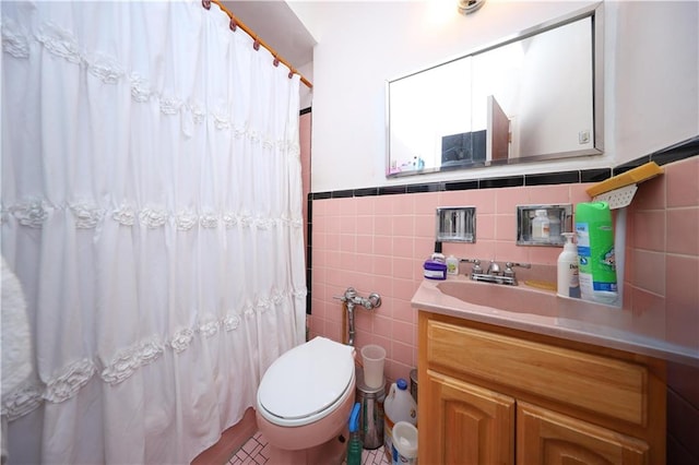 1296 E 54th St, Brooklyn, NY 11234 - full bathroom featuring tile walls, vanity, a shower with shower curtain, and a wainscoted wall
