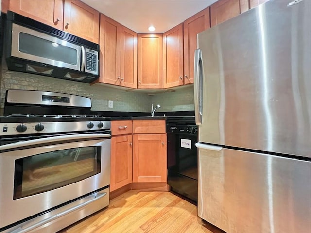 9935 Shore Rd Unit 1D, Brooklyn, NY 11209 - kitchen with appliances with stainless steel finishes, light wood-style floors, dark countertops, decorative backsplash, and recessed lighting
