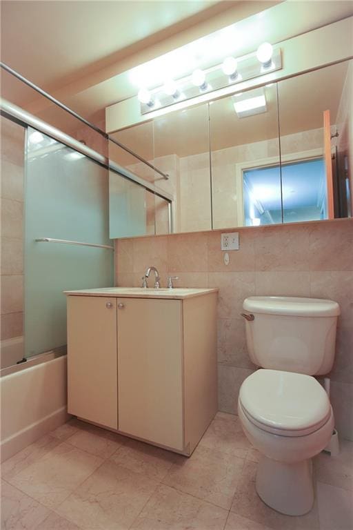 9935 Shore Rd Unit 1D, Brooklyn, NY 11209 - bathroom with tile walls, vanity, shower / tub combination, and tile patterned flooring