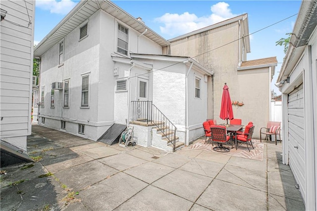 977 80th St, Brooklyn, NY 11228 - back of property with a patio, stucco siding, and outdoor dining space
