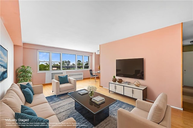 2942 W 5th St Apt 5-N, Brooklyn, NY 11224 - living room featuring radiator heating unit and wood finished floors