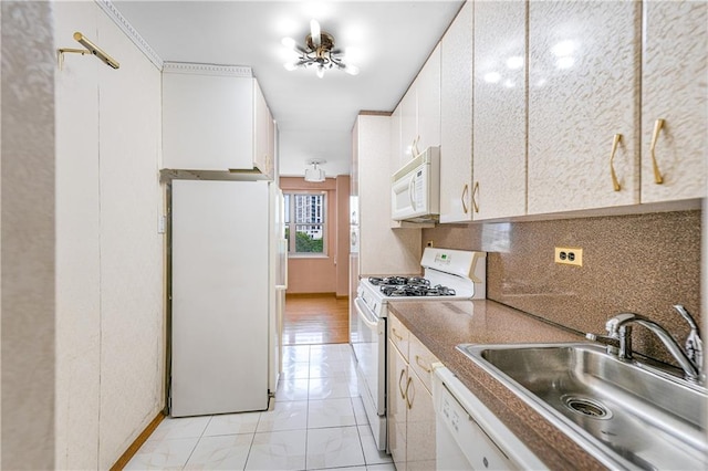 2942 W 5th St Apt 5-N, Brooklyn, NY 11224 - kitchen featuring white appliances, white cabinetry, and tasteful backsplash