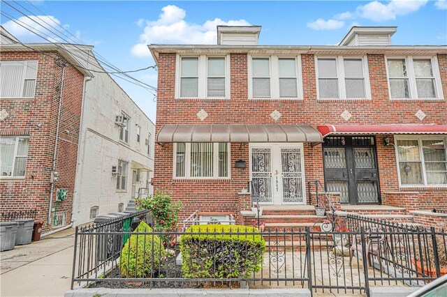 1527 80th St, Brooklyn, NY 11228 - townhome / multi-family property with brick siding and a fenced front yard