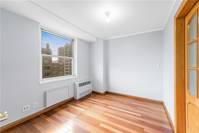 35 Seacoast Ter Unit 8A, Brooklyn, NY 11235 - empty room featuring radiator heating unit, light wood-type flooring, and ornamental molding