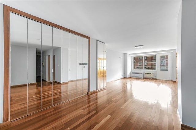 35 Seacoast Ter Unit 8A, Brooklyn, NY 11235 - spare room with radiator heating unit and wood finished floors