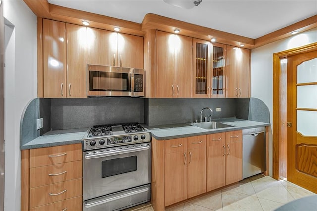 35 Seacoast Ter Unit 8A, Brooklyn, NY 11235 - kitchen with stainless steel appliances, tasteful backsplash, glass insert cabinets, and light tile patterned floors