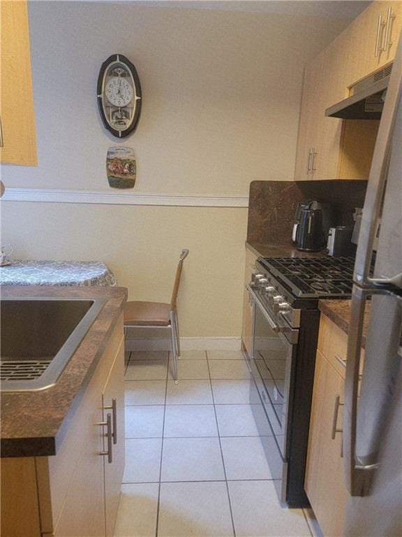 388 Avenue S Unit 2C, Brooklyn, NY 11223 - kitchen featuring stainless steel appliances, under cabinet range hood, dark countertops, and light tile patterned floors