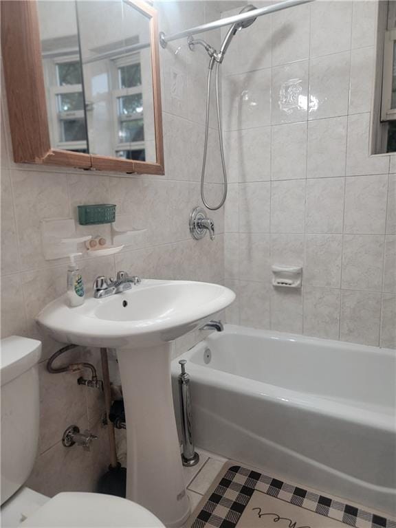 388 Avenue S Unit 2C, Brooklyn, NY 11223 - bathroom featuring tile walls, shower / tub combination, tile patterned floors, and tasteful backsplash