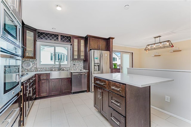 161 Ravenhurst Ave, Staten Island, NY 10310 - kitchen with stainless steel appliances, dark brown cabinets, light countertops, glass insert cabinets, and a center island