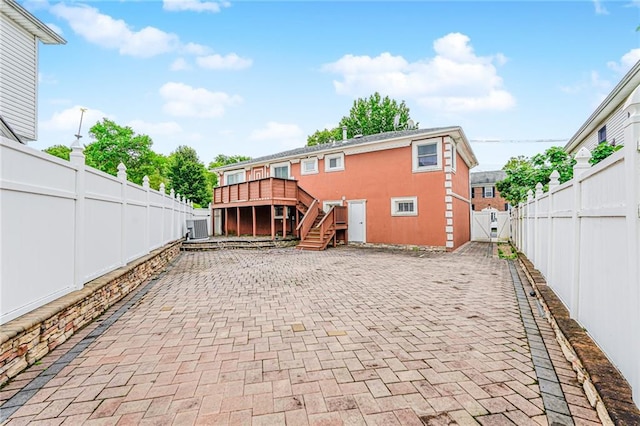 161 Ravenhurst Ave, Staten Island, NY 10310 - rear view of house featuring stairway, a fenced backyard, a deck, and a patio area