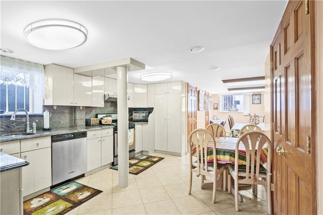 2045 W 11th St, Brooklyn, NY 11223 - kitchen with stainless steel appliances, light tile patterned flooring, tasteful backsplash, and white cabinetry