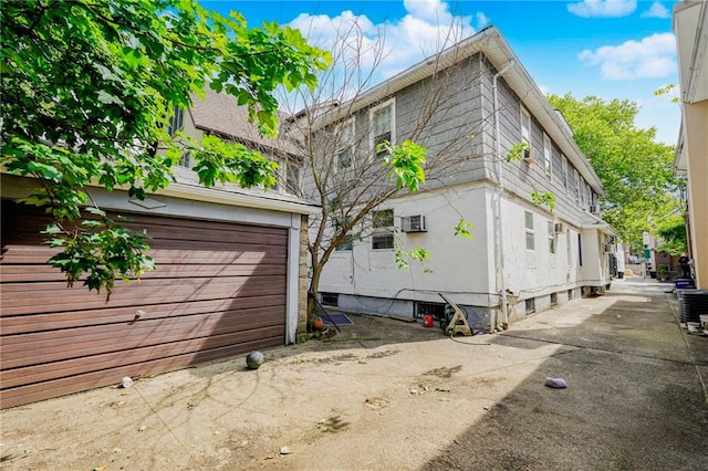 1174 E 9th St, Brooklyn, NY 11230 - view of side of home with stucco siding and a central AC unit