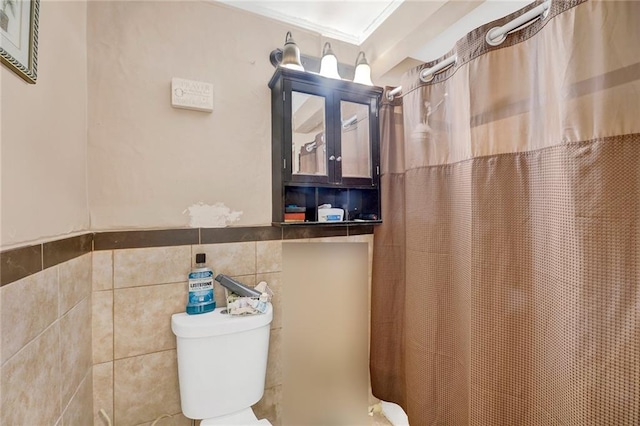 1650 E 48th St, Brooklyn, NY 11234 - full bath with tile walls, a shower with curtain, and a wainscoted wall