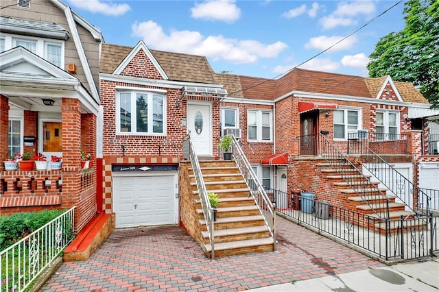 1650 E 48th St, Brooklyn, NY 11234 - view of front of property featuring brick siding, an attached garage, roof with shingles, and decorative driveway