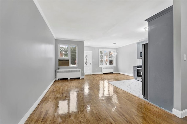 1650 E 48th St, Brooklyn, NY 11234 - unfurnished living room featuring radiator, ornamental molding, light wood finished floors, and cooling unit
