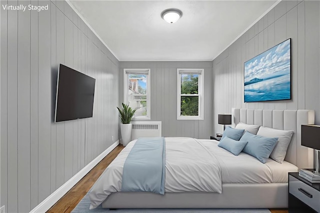 1650 E 48th St, Brooklyn, NY 11234 - bedroom featuring wood finished floors, radiator heating unit, crown molding, and wooden walls