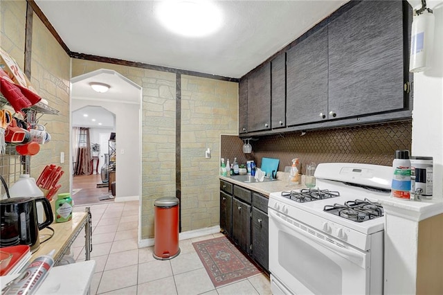 1650 E 48th St, Brooklyn, NY 11234 - kitchen with gas range gas stove, light tile patterned floors, light countertops, ornamental molding, and backsplash