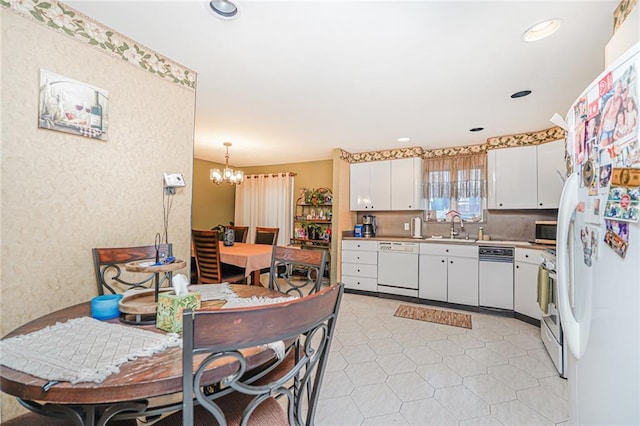 443 Ridgewood Ave, Staten Island, NY 10312 - kitchen with appliances with stainless steel finishes, white cabinetry, a chandelier, hanging light fixtures, and light countertops